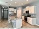 Bright, modern kitchen with granite island, stainless steel appliances, and tiled flooring at 10126 Beach Port Dr, Winter Garden, FL 34787