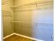 Walk-in closet with shelving, providing ample storage space, and laminate wood floors at 10126 Beach Port Dr, Winter Garden, FL 34787