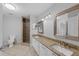 Bright bathroom with double sinks, granite counters, tile floors, and walk-in shower at 1013 Inlet Way, Altamonte Springs, FL 32714