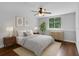 Comfortable bedroom with hardwood floors, a ceiling fan, and a large window at 1013 Inlet Way, Altamonte Springs, FL 32714