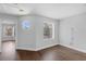 An empty bedroom with laminate wood flooring, and two windows at 1013 Inlet Way, Altamonte Springs, FL 32714