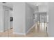 Entry hallway leads to a living space with bright white cabinets, tile floor and natural light at 1013 Inlet Way, Altamonte Springs, FL 32714