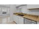 A kitchen with white cabinets, granite countertops, stainless steel dishwasher, and tile floors at 1013 Inlet Way, Altamonte Springs, FL 32714