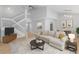 Spacious living room featuring a staircase, modern decor, and natural light at 1013 Inlet Way, Altamonte Springs, FL 32714