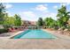 A tranquil community pool surrounded by plenty of lounge chairs with lush green landscaping for residents to enjoy at 1013 Inlet Way, Altamonte Springs, FL 32714