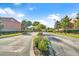 A community entrance with landscaping and a wide street, welcoming residents and visitors alike at 1013 Inlet Way, Altamonte Springs, FL 32714