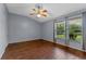 Bedroom boasts hardwood floors, neutral paint, large windows, and backyard views at 10143 Pink Carnation Ct, Orlando, FL 32825