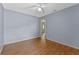 Bedroom features hardwood floors, neutral paint, and a closet at 10143 Pink Carnation Ct, Orlando, FL 32825