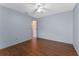 Bedroom features hardwood floors, neutral paint, and a closet at 10143 Pink Carnation Ct, Orlando, FL 32825