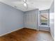 Bedroom features hardwood floors, neutral paint, and a window bench at 10143 Pink Carnation Ct, Orlando, FL 32825