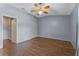 Spacious bedroom featuring wood-look flooring, ceiling fan, and closet at 10143 Pink Carnation Ct, Orlando, FL 32825