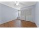 Bedroom features hardwood floors, neutral paint, and a closet at 10143 Pink Carnation Ct, Orlando, FL 32825