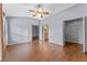 Bedroom featuring wood-look flooring, a ceiling fan and access to the bathroom and closet at 10143 Pink Carnation Ct, Orlando, FL 32825