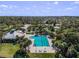 Aerial view of a community pool, clubhouse, playground, tennis courts surrounded by lush landscaping at 10143 Pink Carnation Ct, Orlando, FL 32825
