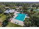 Aerial view of a community pool, clubhouse, playground, tennis courts surrounded by lush landscaping at 10143 Pink Carnation Ct, Orlando, FL 32825