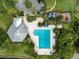 Aerial view showing pool and recreation area with mature trees, a pool house, and playground at 10143 Pink Carnation Ct, Orlando, FL 32825