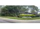 Entrance to Cypress Springs with lush landscaping and signage at 10143 Pink Carnation Ct, Orlando, FL 32825
