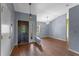 Inviting foyer with a decorative front door, chandelier, and stylish wood flooring at 10143 Pink Carnation Ct, Orlando, FL 32825