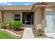 Close-up of the front entrance featuring a screen door and landscaped walkway at 10143 Pink Carnation Ct, Orlando, FL 32825