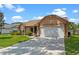Charming single-story home featuring a well-manicured lawn, inviting front entrance, and two car garage at 10143 Pink Carnation Ct, Orlando, FL 32825