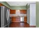 Modern kitchen featuring stainless steel appliances, wood cabinets, and granite countertops at 10143 Pink Carnation Ct, Orlando, FL 32825