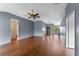 Large living room featuring hardwood floors, a ceiling fan, and a view of the front entryway at 10143 Pink Carnation Ct, Orlando, FL 32825