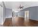 Inviting living room showcasing hardwood floors, cool paint, and a modern ceiling fan at 10143 Pink Carnation Ct, Orlando, FL 32825