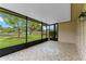 Screened in patio featuring tile flooring and backyard views with lake access at 10143 Pink Carnation Ct, Orlando, FL 32825