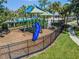 View of the community playground featuring a blue slide and climbing structure with shade at 10143 Pink Carnation Ct, Orlando, FL 32825
