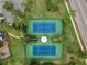 Overhead shot of tennis courts in a verdant setting, complete with a central gazebo and mature trees at 10143 Pink Carnation Ct, Orlando, FL 32825