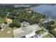 Aerial view of a luxurious home nestled among lush trees with a sparkling lake nearby, offering privacy and scenic beauty at 11923 Lake Butler Blvd, Windermere, FL 34786
