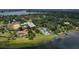 Panoramic aerial view of a lakeside home with mature trees offering serene living with a private dock at 11923 Lake Butler Blvd, Windermere, FL 34786