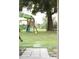 Backyard with a play set and a mature shade tree at 11923 Lake Butler Blvd, Windermere, FL 34786