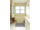 Bright bathroom featuring a tub, vanity, and window, creating a clean and inviting atmosphere at 11923 Lake Butler Blvd, Windermere, FL 34786