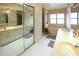 Bathroom with double vanity, mirror, and bathtub with window, creating a bright space at 11923 Lake Butler Blvd, Windermere, FL 34786