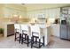 Kitchen with white cabinetry, tile flooring, and a central island with seating at 11923 Lake Butler Blvd, Windermere, FL 34786