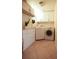 Neat laundry room with storage cabinets, washer and dryer, and tiled floor at 11923 Lake Butler Blvd, Windermere, FL 34786