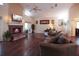 Inviting living room featuring a cozy fireplace, hardwood floors, and ample natural light, creating a warm and welcoming atmosphere at 11923 Lake Butler Blvd, Windermere, FL 34786