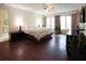 Large main bedroom with hardwood floors, a ceiling fan, and natural light from the windows at 11923 Lake Butler Blvd, Windermere, FL 34786