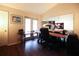 Home office area featuring dark hardwood floors, a doorway to outside, and dual monitors at 11923 Lake Butler Blvd, Windermere, FL 34786
