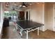 Spacious screened porch with lights, ceiling fan, and a ping pong table at 11923 Lake Butler Blvd, Windermere, FL 34786
