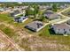 An aerial view of homes in a quiet neighborhood surrounded by trees and greenery at 123 Zinnia W Ln, Poinciana, FL 34759