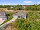 An aerial view shows the house with solar panels and a covered porch with a seating area at 123 Zinnia W Ln, Poinciana, FL 34759