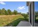 Backyard with a concrete patio and a view of trees in the distance at 123 Zinnia W Ln, Poinciana, FL 34759