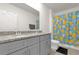Bathroom featuring double sinks, gray cabinets, and a granite countertop at 123 Zinnia W Ln, Poinciana, FL 34759