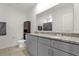 Bathroom featuring double sinks, gray cabinets, and a granite countertop at 123 Zinnia W Ln, Poinciana, FL 34759