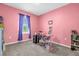 Cozy room with desk, closet, and pink walls at 123 Zinnia W Ln, Poinciana, FL 34759