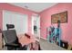 Cozy room with desk, closet, and pink walls at 123 Zinnia W Ln, Poinciana, FL 34759