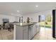 Spacious kitchen island with granite countertops and stainless steel dishwasher, perfect for entertaining at 123 Zinnia W Ln, Poinciana, FL 34759