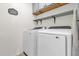 Laundry room featuring white cabinets, shelving, and appliances at 123 Zinnia W Ln, Poinciana, FL 34759